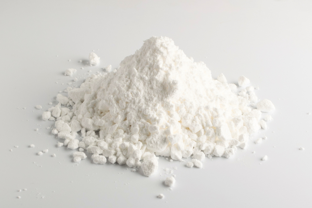 small pile of Alexandria Professional's Body Comfort drying powder for odor control and chaffing prevention