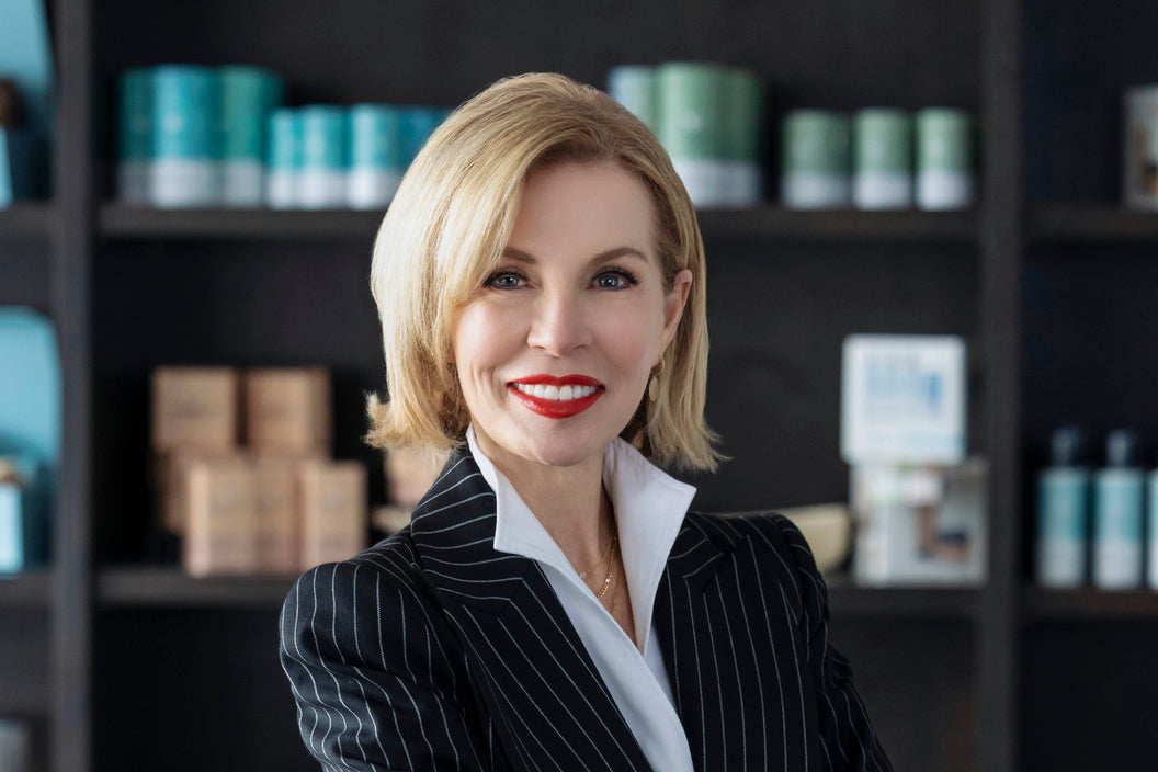 a photo of founder and CEO Lina Kennedy in front of the Alexandria Professional retail product line